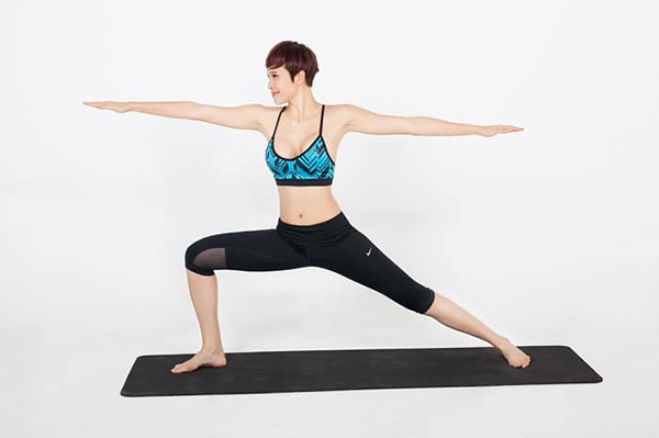 The standard posture of yoga exercises at home warrior position 2.